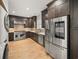Modern kitchen features stainless steel appliances, light wood floors, and dark wood cabinets at 302A 32Nd Ave. N, North Myrtle Beach, SC 29582