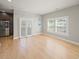 Bright, open living area featuring wood floors, light walls, stainless appliances, and large windows at 302A 32Nd Ave. N, North Myrtle Beach, SC 29582
