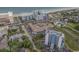 Aerial view of property, including buildings, pool, parking lot, landscaping, and ocean at 6803 N Ocean Blvd. # 210, Myrtle Beach, SC 29572