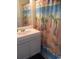 Bright bathroom with a patterned shower curtain and white vanity at 6803 N Ocean Blvd. # 210, Myrtle Beach, SC 29572