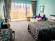 Bright bedroom with sliding glass doors leading to a balcony and outdoor view at 6803 N Ocean Blvd. # 210, Myrtle Beach, SC 29572