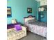 Bright bedroom with colorful bedding and a sunset picture hanging on the wall at 6803 N Ocean Blvd. # 210, Myrtle Beach, SC 29572