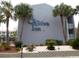 Facade of St. John's Inn building, displaying its signage and surrounding greenery at 6803 N Ocean Blvd. # 210, Myrtle Beach, SC 29572