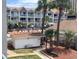 Exterior of condominium complex with outdoor pool and palm tree landscaping at 6803 N Ocean Blvd. # 210, Myrtle Beach, SC 29572