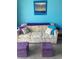 Cozy living room with a comfortable couch and ottoman seating with a decorative ocean view art piece at 6803 N Ocean Blvd. # 210, Myrtle Beach, SC 29572