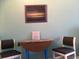 Sitting area with two chairs and a small table, decorated with an evening photo at 6803 N Ocean Blvd. # 210, Myrtle Beach, SC 29572