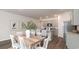 Light and airy dining room with a farmhouse-style table and chairs at 7223 Meadow Walk Loop, Loris, SC 29569