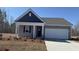 Charming single-story home featuring a covered front porch and attached two-car garage in a well-maintained community at 7287 Meadow Walk Loop, Loris, SC 29569