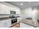 Kitchen with granite counters, stainless appliances, and white cabinets creates a modern, stylish space at 109 Arrow Wood Dr, Conway, SC 29526