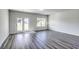 Bright living room with doors to yard, large windows and wood-look floors, creating inviting space at 109 Arrow Wood Dr, Conway, SC 29526