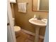 Cozy bathroom featuring a pedestal sink, warm tones, and a wall-mounted towel rack at 1095 West Plantation Dr. # 28-I, Little River, SC 29566