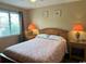 Cozy bedroom featuring a large window, comfortable bed, and bedside tables with lamps at 1095 West Plantation Dr. # 28-I, Little River, SC 29566