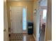 Inviting entryway with a decorative beach sign, tiled flooring, and a glimpse of a bedroom at 1095 West Plantation Dr. # 28-I, Little River, SC 29566