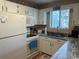 Functional kitchen with white cabinetry, granite countertops, and essential appliances for meal preparation at 1095 West Plantation Dr. # 28-I, Little River, SC 29566