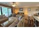 Living room with sliding glass doors, comfortable seating, and an adjacent dining area at 1095 West Plantation Dr. # 28-I, Little River, SC 29566