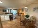 Combined living and dining area with comfortable seating, a dining table, and an open layout at 1095 West Plantation Dr. # 28-I, Little River, SC 29566