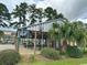 Outdoor pool surrounded by lush greenery, mature trees, and a secured fence at 1095 West Plantation Dr. # 28-I, Little River, SC 29566