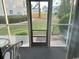 Enclosed porch featuring a screened door, view of the yard, and a small gravel area at 1095 West Plantation Dr. # 28-I, Little River, SC 29566