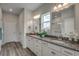 Bathroom featuring double vanity sinks with granite countertops, complemented by modern lighting at 110 Arrow Wood Dr, Conway, SC 29526