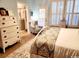 Bedroom featuring a dresser and a window view, with an adjacent sitting area offering a cozy retreat at 2256 Heritage Loop # 2256, Myrtle Beach, SC 29577