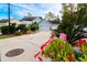 Attractive home exterior with a spacious driveway and lush landscaping under a partly cloudy sky at 2256 Heritage Loop # 2256, Myrtle Beach, SC 29577
