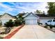 Charming home exterior with well-maintained landscaping, featuring a spacious driveway and inviting curb appeal at 2256 Heritage Loop # 2256, Myrtle Beach, SC 29577