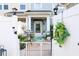Inviting front porch with red door, bistro table, and decorative wreaths and potted plants at 2256 Heritage Loop # 2256, Myrtle Beach, SC 29577