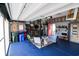Spacious garage with blue epoxy floor, custom storage, seating and refrigerator at 2256 Heritage Loop # 2256, Myrtle Beach, SC 29577