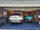 Well-organized garage featuring storage solutions, a car, and a golf cart at 2256 Heritage Loop # 2256, Myrtle Beach, SC 29577