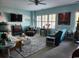 Spacious living room with a ceiling fan, large windows, comfortable seating, and stylish decor, perfect for relaxing at 2256 Heritage Loop # 2256, Myrtle Beach, SC 29577