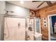Bathroom shower with glass doors, wooden wall paneling, and stylish storage solutions at 2256 Heritage Loop # 2256, Myrtle Beach, SC 29577