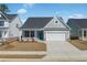 Charming single-story home with a well-manicured lawn, a two-car garage, and a welcoming blue front door at 2469 Campton Loop, Conway, SC 29527