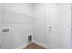 Bright laundry room featuring durable flooring, white walls, shelving and exterior access at 2469 Campton Loop, Conway, SC 29527