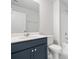 A well-lit bathroom features a dark vanity, white countertop, and tiled flooring for a clean, modern aesthetic at 2480 Campton Loop, Conway, SC 29527