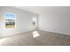 Bright bedroom with two windows providing natural light and neighborhood views, and neutral carpeting at 2480 Campton Loop, Conway, SC 29527