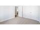 A bedroom featuring carpeted flooring and a view into the kitchen through an open doorway at 2480 Campton Loop, Conway, SC 29527
