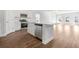 Modern kitchen featuring white cabinets, stainless steel appliances, and hardwood flooring at 2480 Campton Loop, Conway, SC 29527