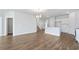 Open-concept living space with a kitchen island, hardwood floors, and ample natural light at 2480 Campton Loop, Conway, SC 29527