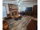 Living room with brick fireplace and laminate wood floors at 354 George Washington Trail, Georgetown, SC 29440