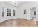 Bright dining room features large windows, wood floors, and modern light fixture at 4650 Quiet Ave., Conway, SC 29527