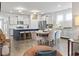Open-concept kitchen and dining area featuring stainless steel appliances, granite counters, island, and wood floors at 4855 Guilford Loop, Myrtle Beach, SC 29588
