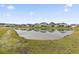 Backyard pond view surrounded by manicured lawn and neighborhood homes at 4855 Guilford Loop, Myrtle Beach, SC 29588