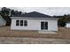 Backyard view with patio, sliding glass door, and a well-maintained lawn at 4963 Old Highway 90, Conway, SC 29526