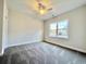 Light-filled bedroom boasting plush carpeting, a ceiling fan, and a large window for natural light at 4963 Old Highway 90, Conway, SC 29526