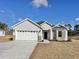 Charming single Gathering home featuring a two-car garage and vinyl siding, complemented by well-manicured landscaping at 4963 Old Highway 90, Conway, SC 29526