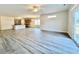 Open-concept living area with wood-look floors, seamlessly connecting the kitchen and dining spaces at 4963 Old Highway 90, Conway, SC 29526