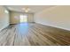 Expansive living room with wood-look floors and sliding glass doors leading to the outdoors at 4963 Old Highway 90, Conway, SC 29526