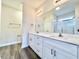Bathroom featuring a double sink vanity with white cabinets, a large mirror, and sleek fixtures at 4971 Old Highway 90, Conway, SC 29526