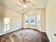 Spacious bedroom featuring a bay window that provides abundant natural light and plush carpet flooring at 4971 Old Highway 90, Conway, SC 29526