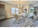 Bright dining area featuring a white table, comfortable seating for four, a large window, and modern decor at 4971 Old Highway 90, Conway, SC 29526